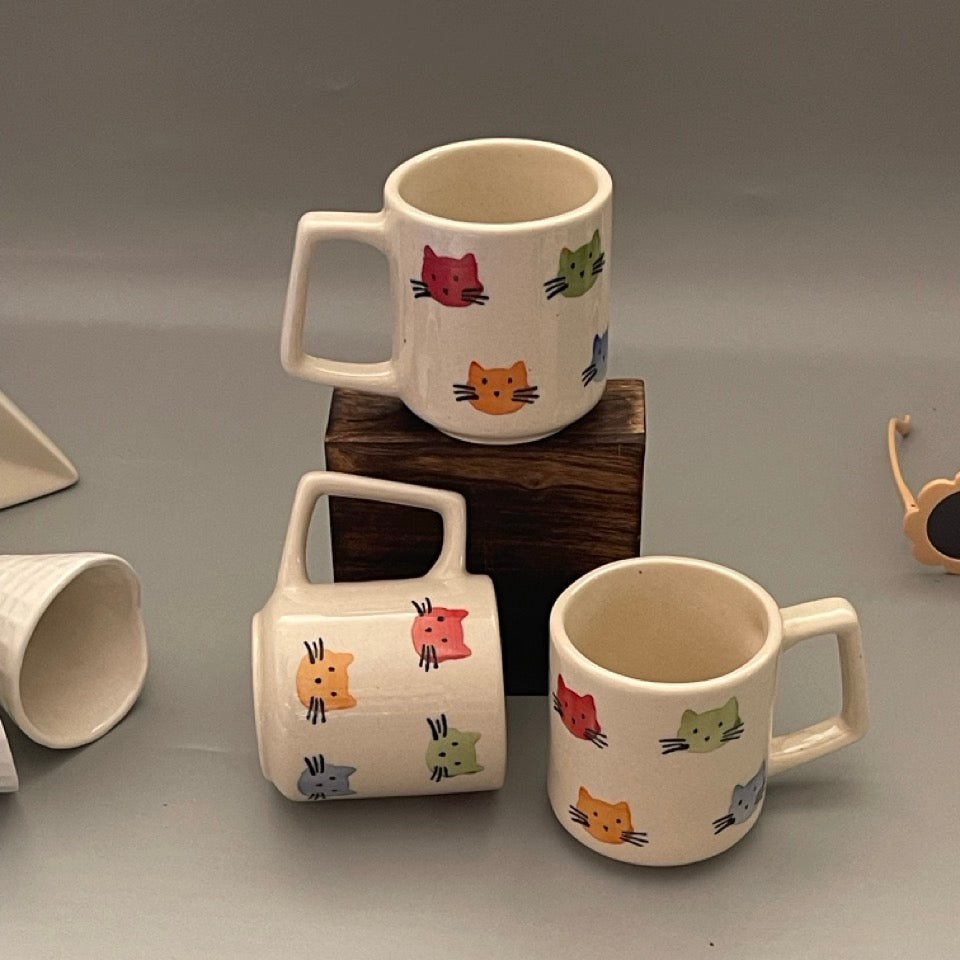 Ceramic milk mugs with cat print design, ideal for cozy drinks