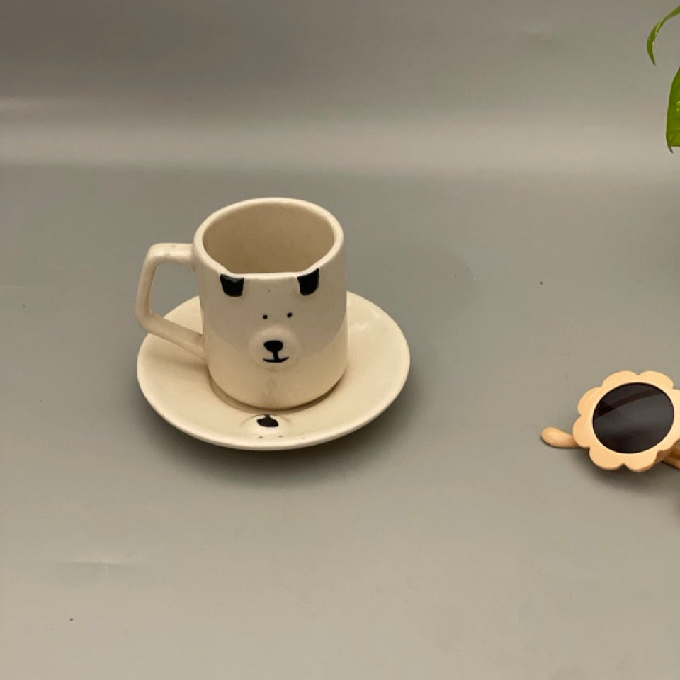 Small ceramic milk mug with dog face and matching dog face saucer