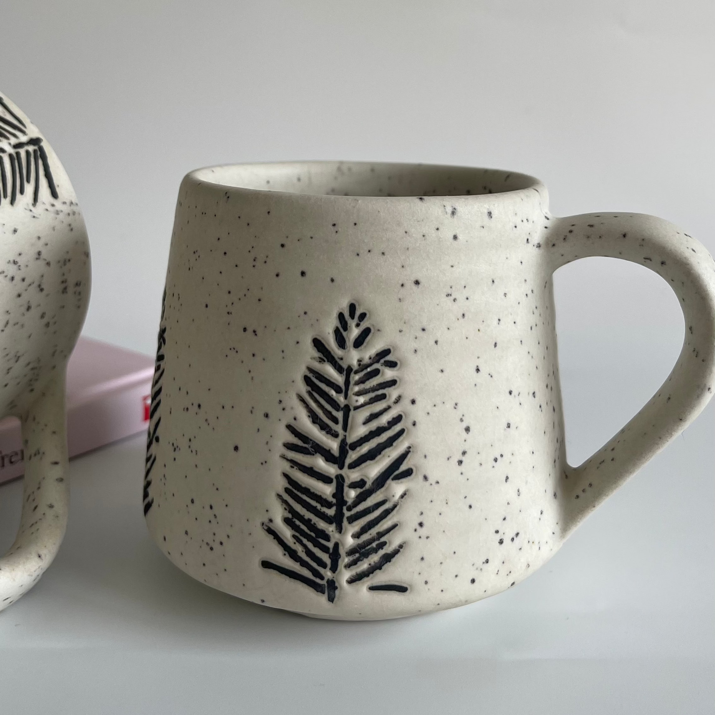 Medium-sized ceramic mug with glyph-style tree design for tea or coffee
