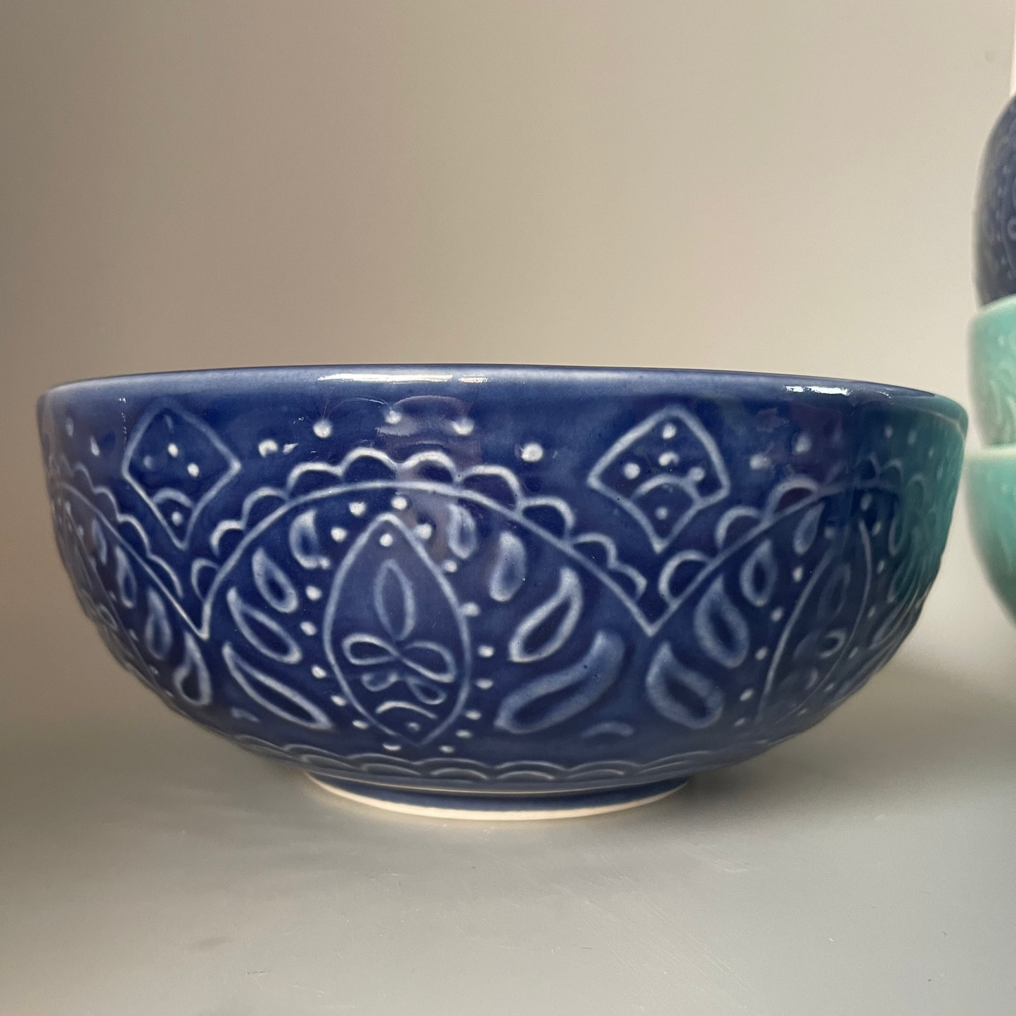8-inch ceramic serve bowl with embossed flower design in blue and teal, perfect for salads, soups, and Indian side dishes