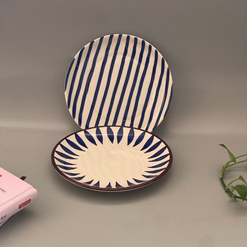 A set of 2 appetiser plates in Royal blue imprints each with a different print