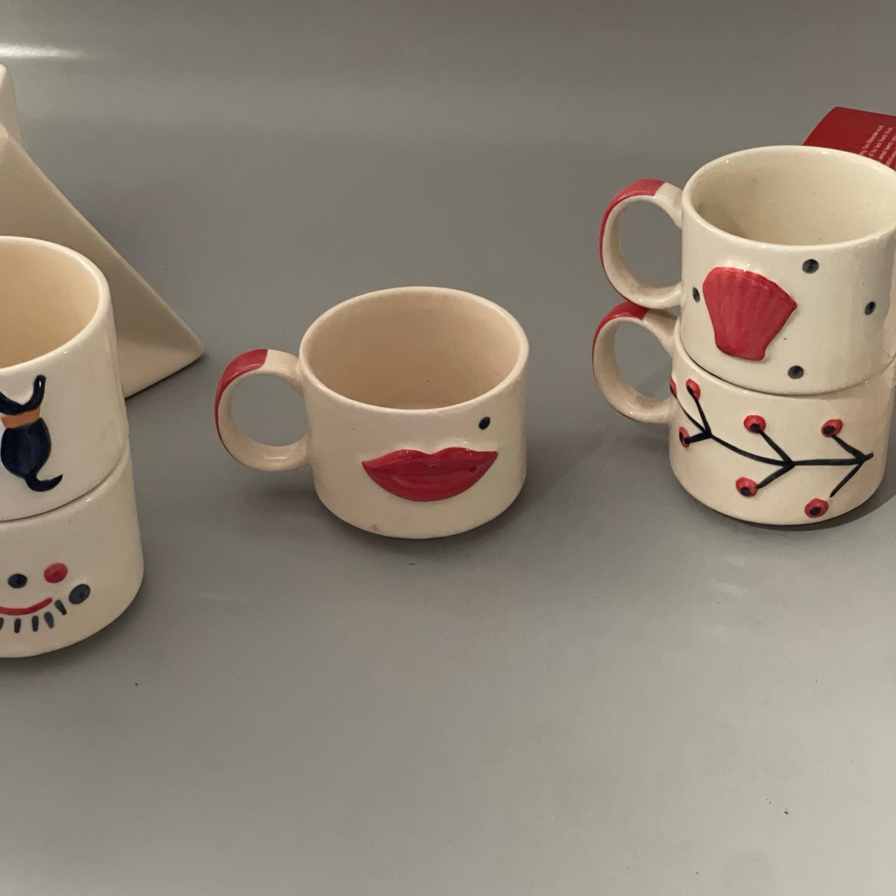 Stackable ceramic cup set of 5 with shell, branch, dog, eyelash and lips motifs