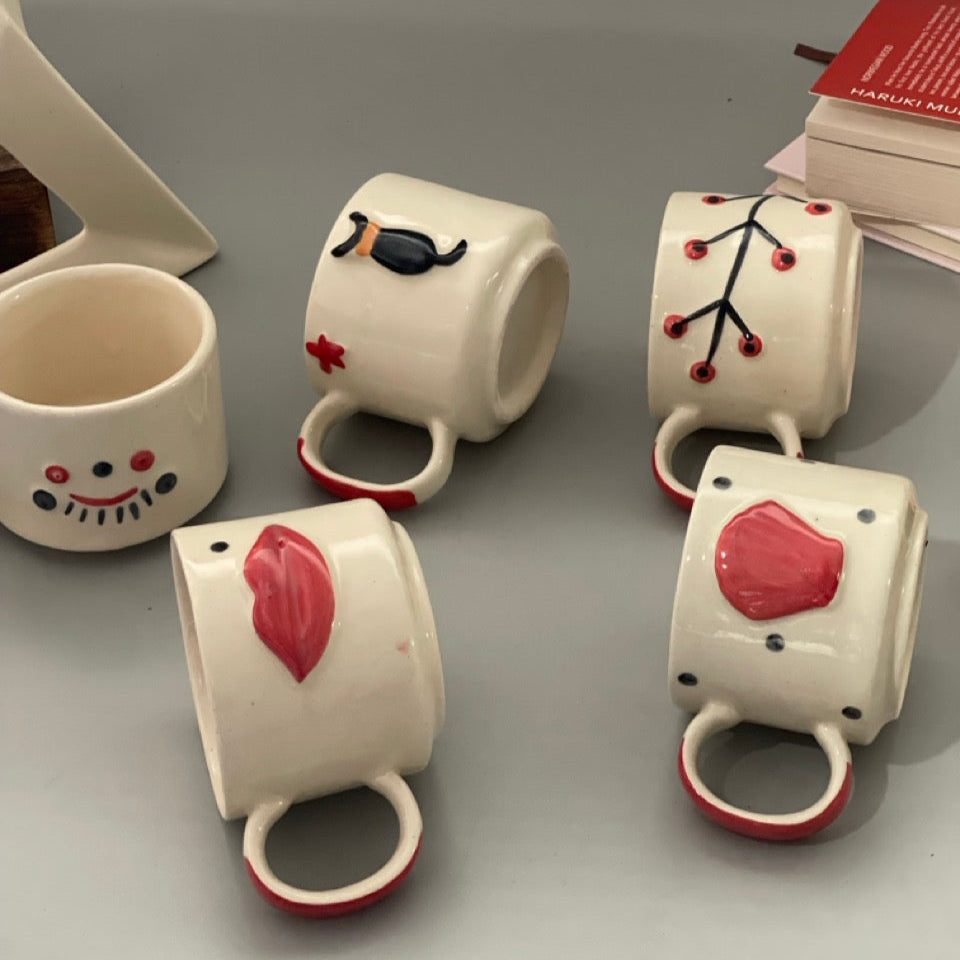 Stackable ceramic cup set of 5 with shell, branch, dog, eyelash and lips motifs