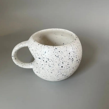 Speckled Apple ceramic mug on a plain background