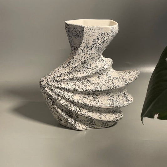 Matte black shell-shaped ceramic vase with sculptural design