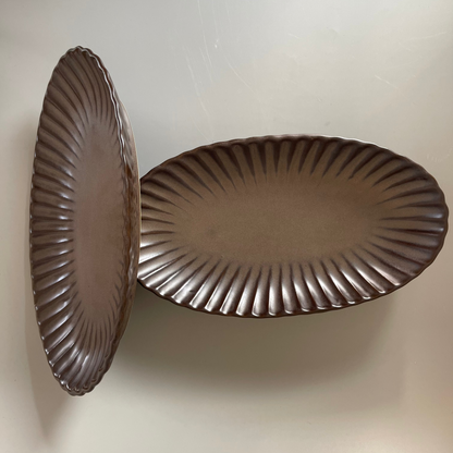 Brown oval ceramic platter with ribbed texture, ideal for serving appetisers or festive snacks