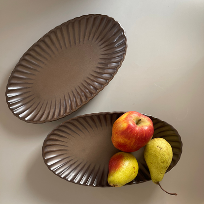 Brown oval ceramic platter with ribbed texture, ideal for serving appetisers or festive snacks