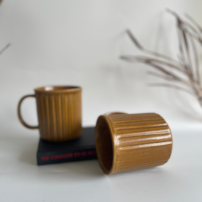 Ceramic ribbed mugs available in pastel purple, pastel blue, and earthy brown