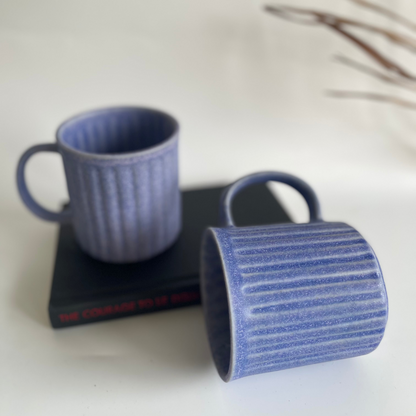 Ceramic ribbed mugs available in pastel purple, pastel blue, and earthy brown