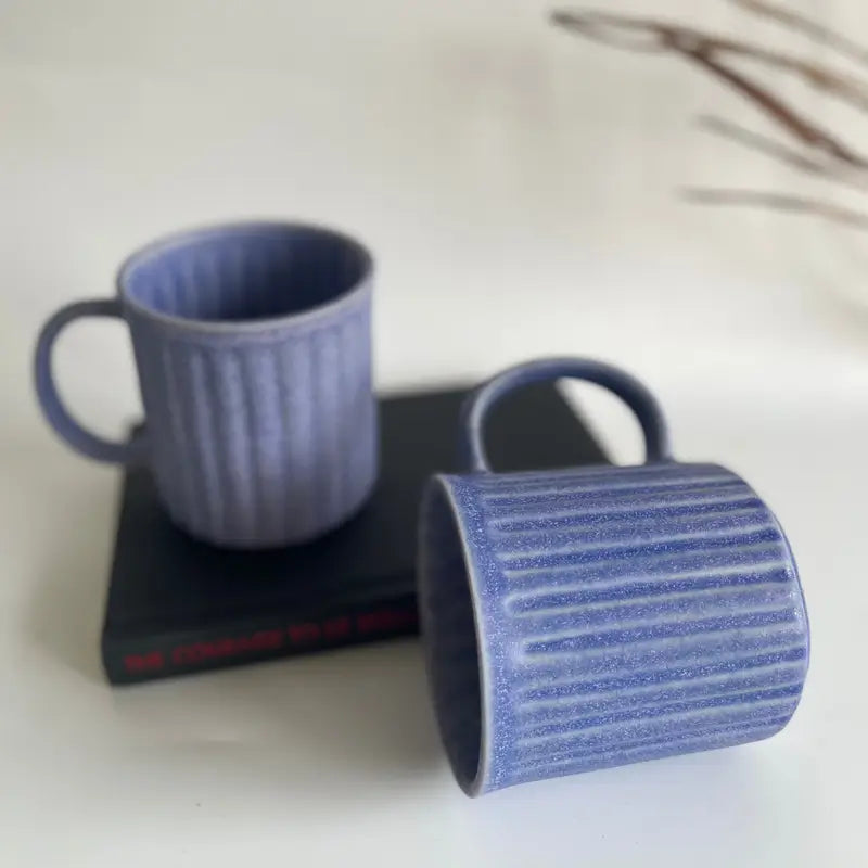 Two Everyday Ribbed mugs pruple on a light surface with a blurred background