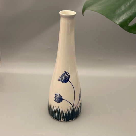 Floral white vase with blue flower and grass print and slender bottle form