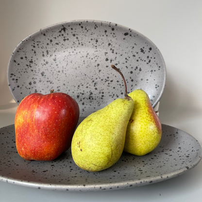 Grey speckled ceramic platter with earthy finish for serving appetisers or festive snacks – rustic and minimal style