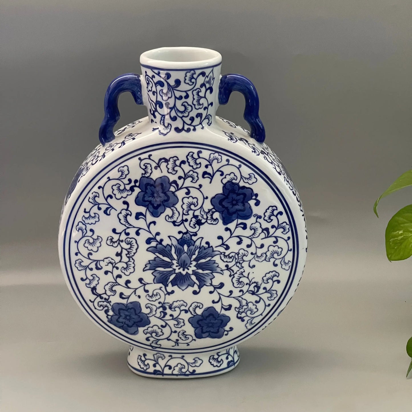Blue and white Hanrui ceramic vase with floral patterns on a gray background
