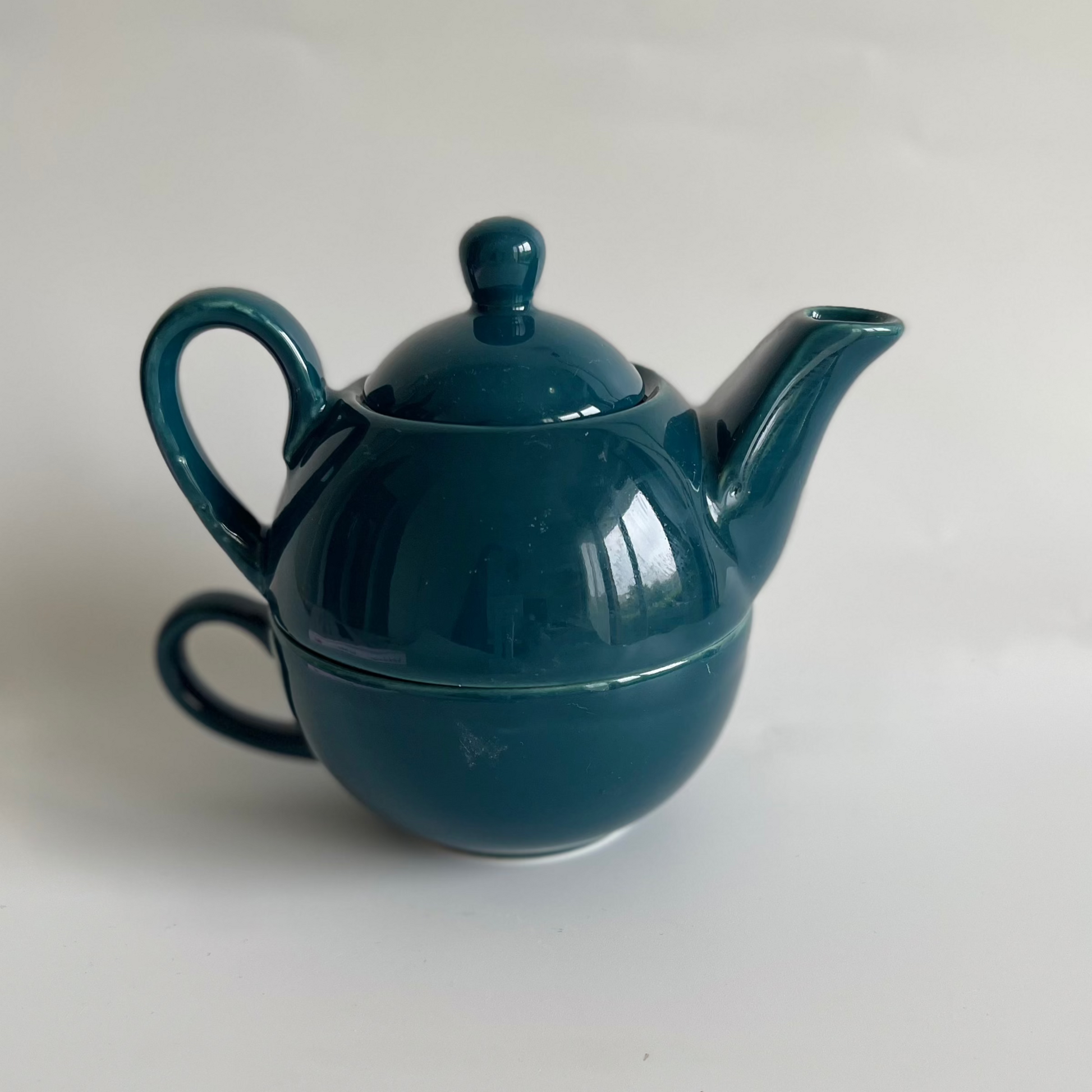 Ceramic one-cup kettle in brown, green, purple, and blue for single-serve tea or coffee
