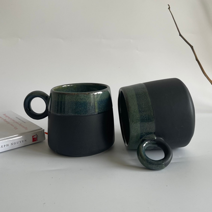 Large ceramic mugs with round orbit handle, available in green-black and white with dotted colors