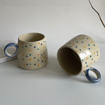 Large ceramic mugs with round orbit handle, available in green-black and white with dotted colors