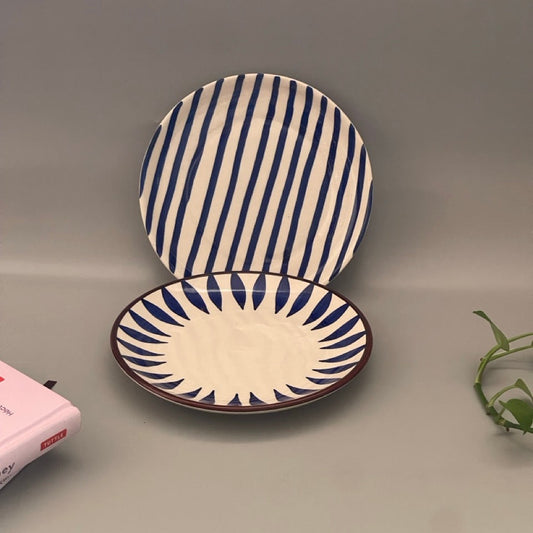 A set of 2 appetiser plates in Royal blue imprints each with a different print