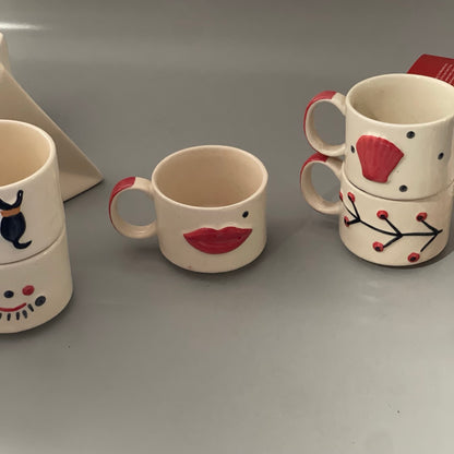 Stackable ceramic cup set of 5 with shell, branch, dog, eyelash and lips motifs