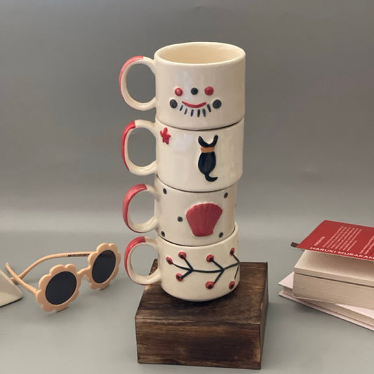 Stackable ceramic cup set of 5 with shell, branch, dog, eyelash and lips motifs
