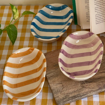 Collection of three striped snack bowls on a table. Perfect for snacking or serving