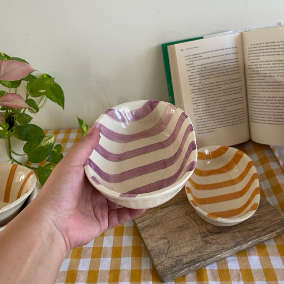Purple striped snack bowls on a table. Perfect for snacking or serving
