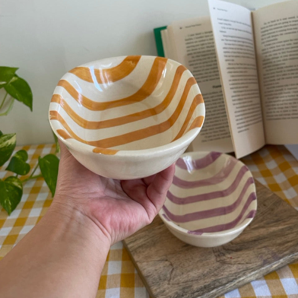 Yellow striped snack bowls on a table. Perfect for snacking or serving