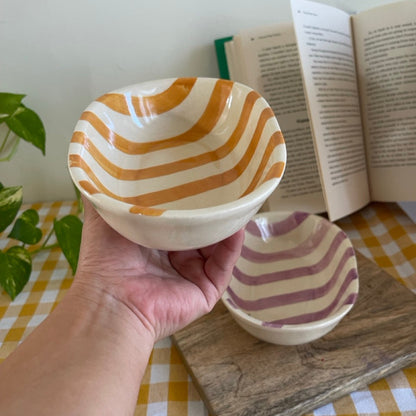 Yellow striped snack bowls on a table. Perfect for snacking or serving