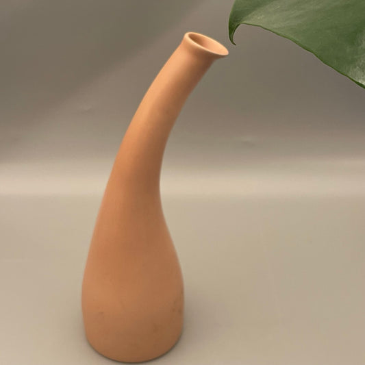 Tall ceramic vase with narrow neck and wide base in solid color finish