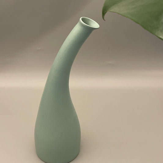 Tall ceramic vase with narrow neck and wide base in solid color finish