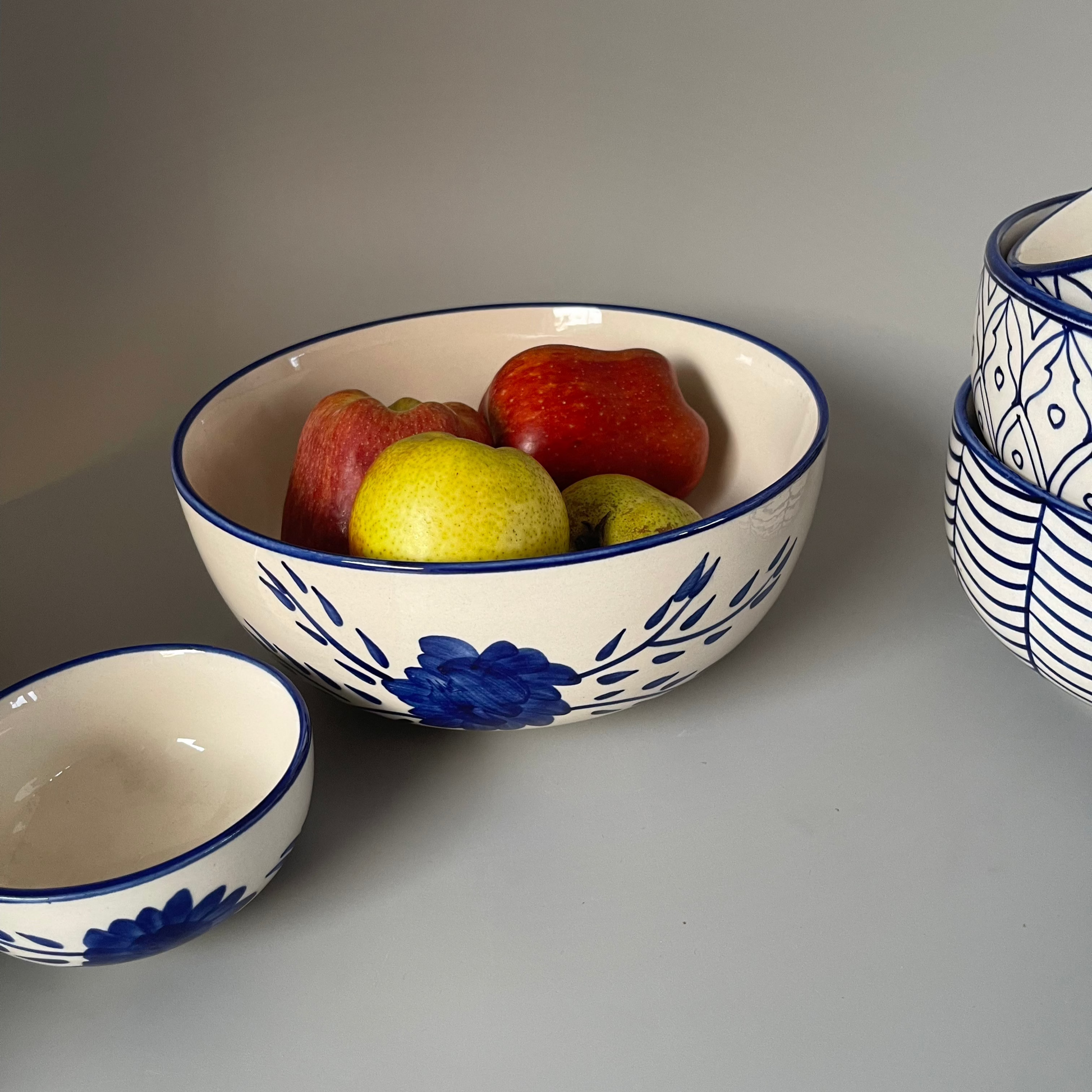 White 8.5 inch ceramic serve bowl with tribal flower motif, perfect for vegetables, grains, and main dishes