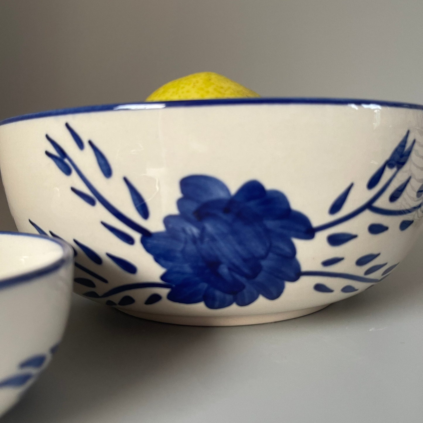 White 8.5 inch ceramic serve bowl with tribal flower motif, perfect for vegetables, grains, and main dishes