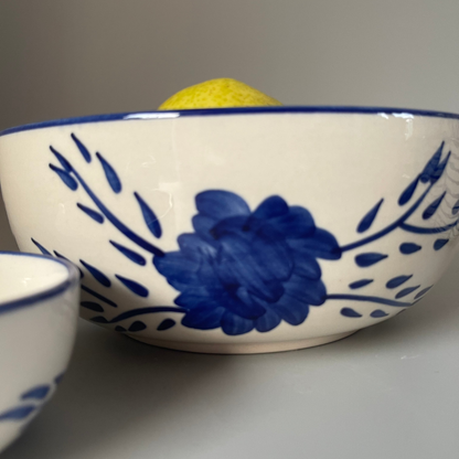 White 8.5 inch ceramic serve bowl with tribal flower motif, perfect for vegetables, grains, and main dishes