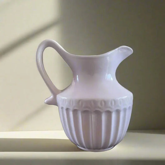White Victorian ceramic pitcher Jug with decorative design on a neutral background