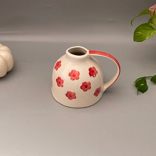 Watering can–shaped white ceramic vase with red floral design, ideal for kitchen shelf or console decor