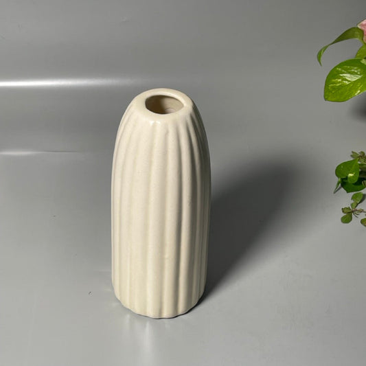 Glossy white ceramic vase with ribbed texture, tall silhouette