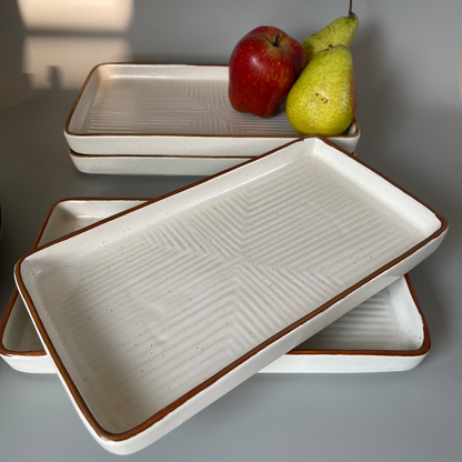 Elegant white ceramic platter with subtle speckles and a gold rim, ideal for serving appetizers, desserts, or main dishes