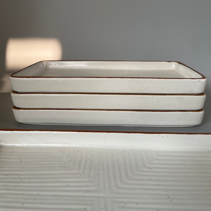 Elegant white ceramic platter with subtle speckles and a gold rim, ideal for serving appetizers, desserts, or main dishes